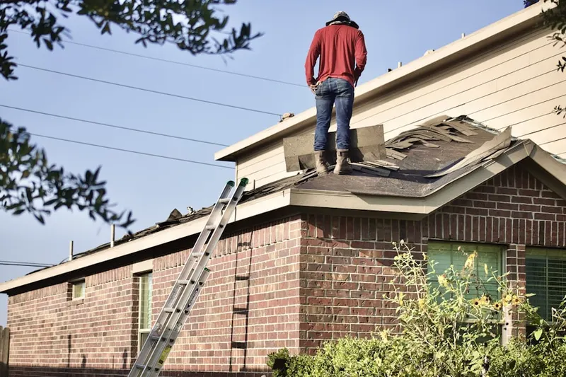 Professional roofer working on a residential roof in Pocasset